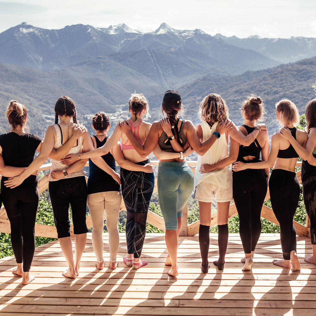 Group of Inedpendent Consultants facing backwards with arms around eachother viewing nature